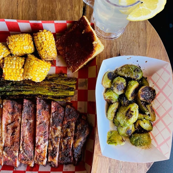 Wilson's Secret Sauce BBQ ribs, corn on the cob, asparagus, cornbread, and roasted Brussels sprouts.